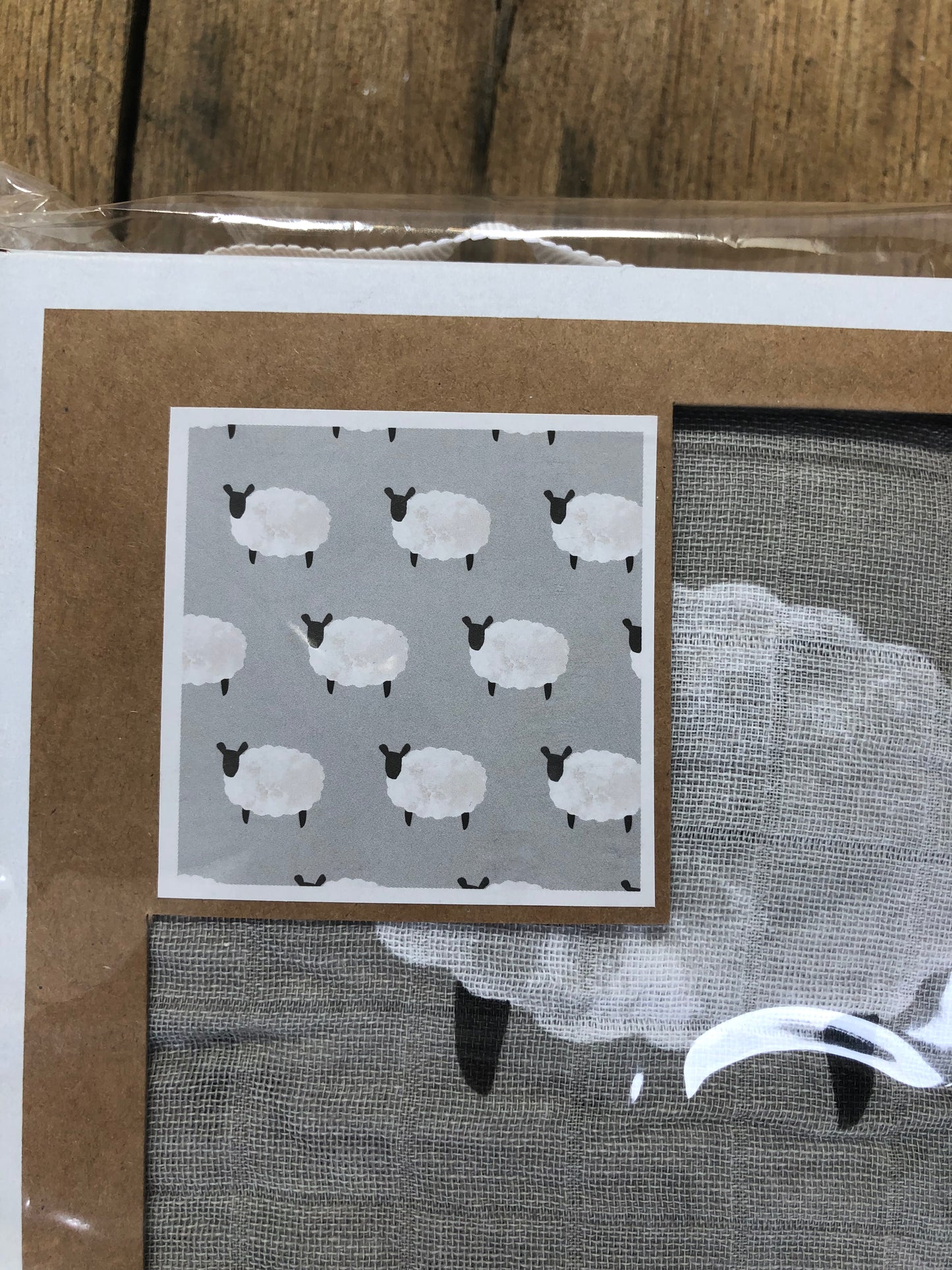 close up of muslin swaddle blanket with sheep for baby