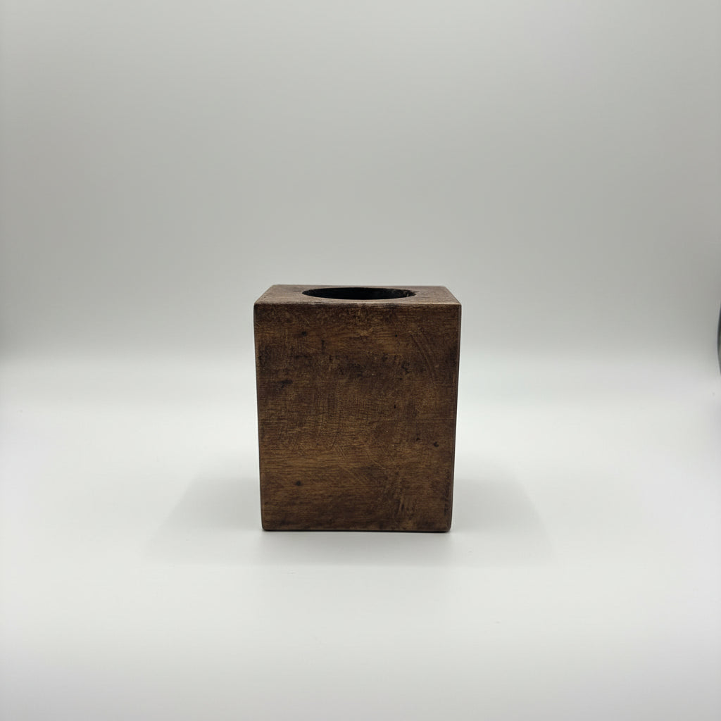 A rustic dark brown wooden box with a circular cutout on top.
