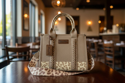 Beige handbag with leopard print strap on a light background