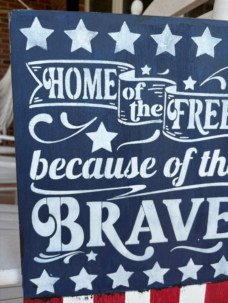 Navy blue sign with white text and stars, featuring patriotic design.