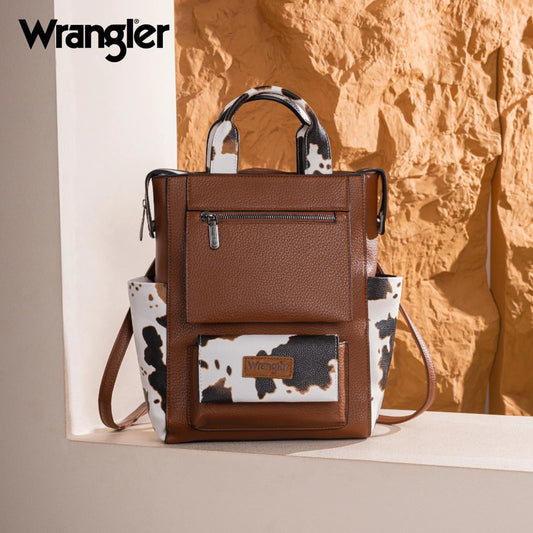 Brown leather backpack with cow print accents on a textured background, featuring the Wrangler brand.