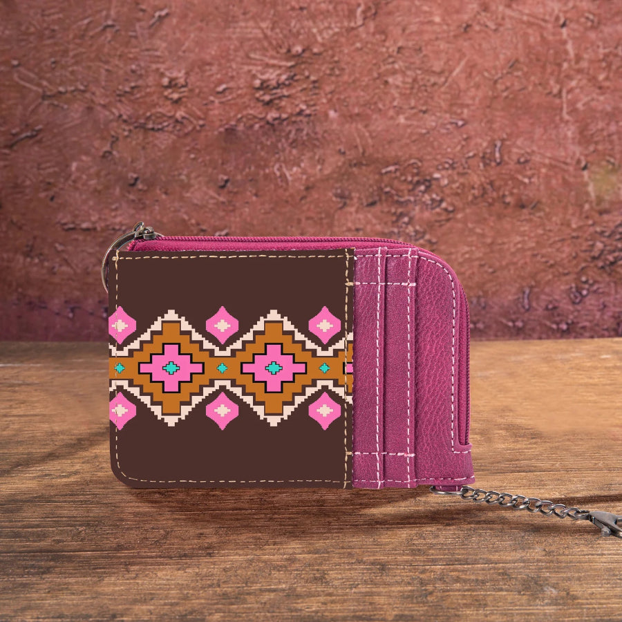Brown wallet with pink and orange pattern on a wooden surface