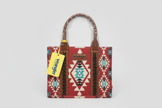 Red patterned handbag with brown handles and a Wrangler tag on a white surface.