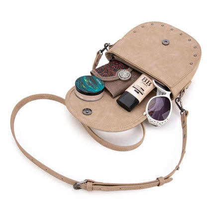 Beige crossbody bag with cosmetic items on a white background