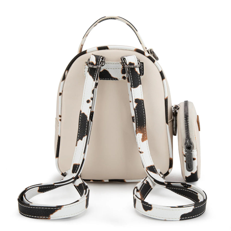 Beige backpack with black and white cow pattern trim on a white background