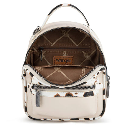 Small tan backpack trimmed with cow print pattern on a white background