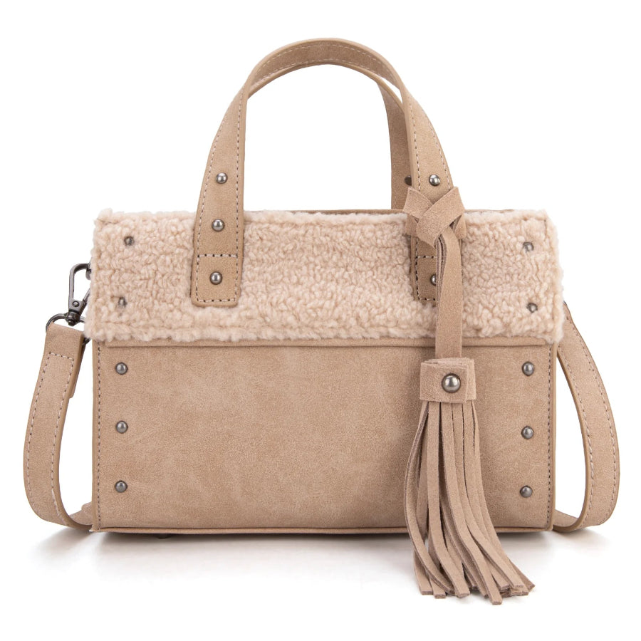 Beige handbag with shearling liner and tassel on a white background