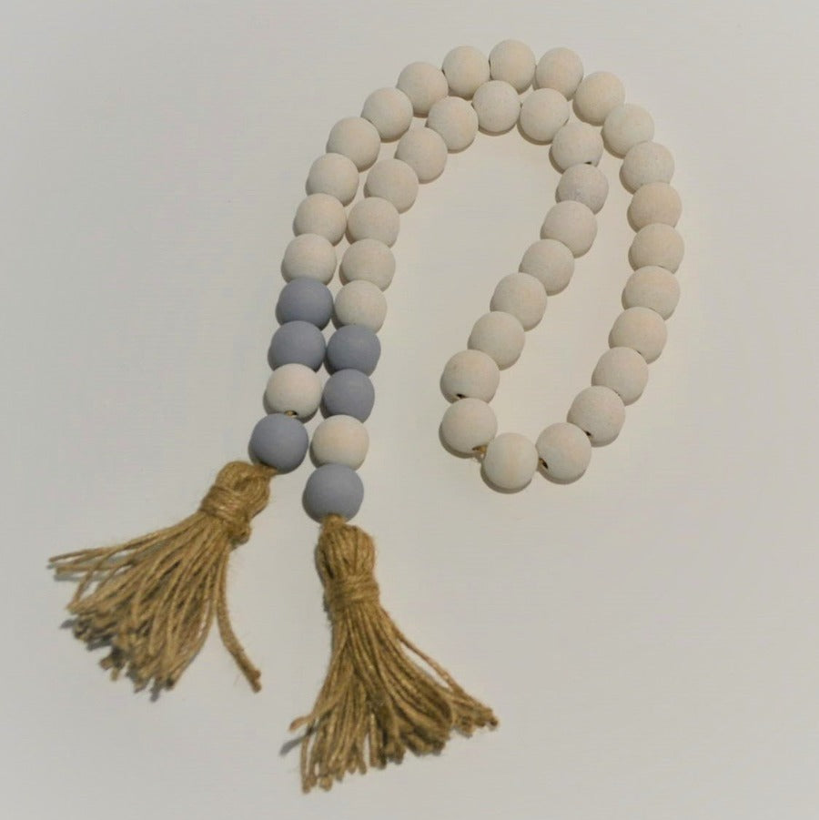 gray & white-washed 20mm beads farmhouse boho wood bead garland with jute tassels on white background