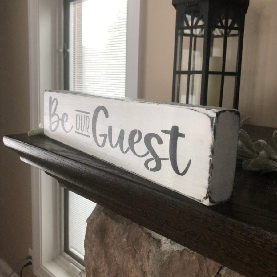 black and white be our guest sign side view