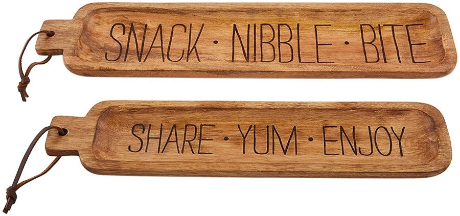 set of 2 nested mango wood snack trays. large one reads snack, nibble, bite. smaller one reads share, yum, enjoy.