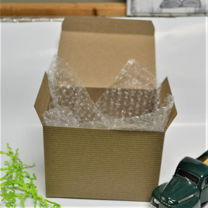 kraft brown gift box ready with a green truck toy